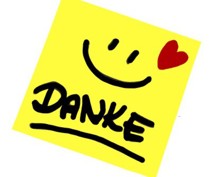 Gelber Notizzettel mit der Beschriftung "Danke", einem lachenden Gesicht und einem roten Herz.